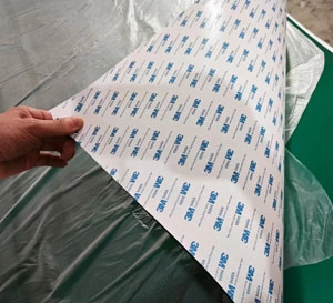 High-tensile cloth-inserted rubber sheets with 3M pressure-sensitive adhesive (PSA) backing, prepared for precision die-cutting. Fabric reinforced and self adhesive backed rubber sheet rolls ready for gasket die cutting